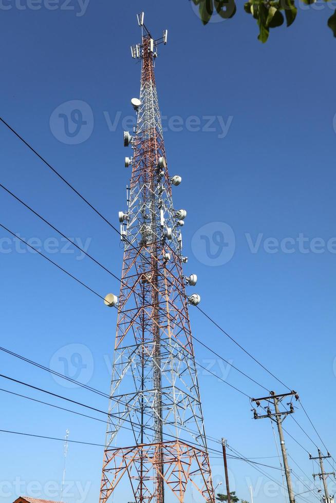 communication tower. Telco Trellis for 3G 4G 5G Apocalypse Internet Communication, mobile, FM Radio and Television Broadcasting On Air with Blue Sky in Background photo