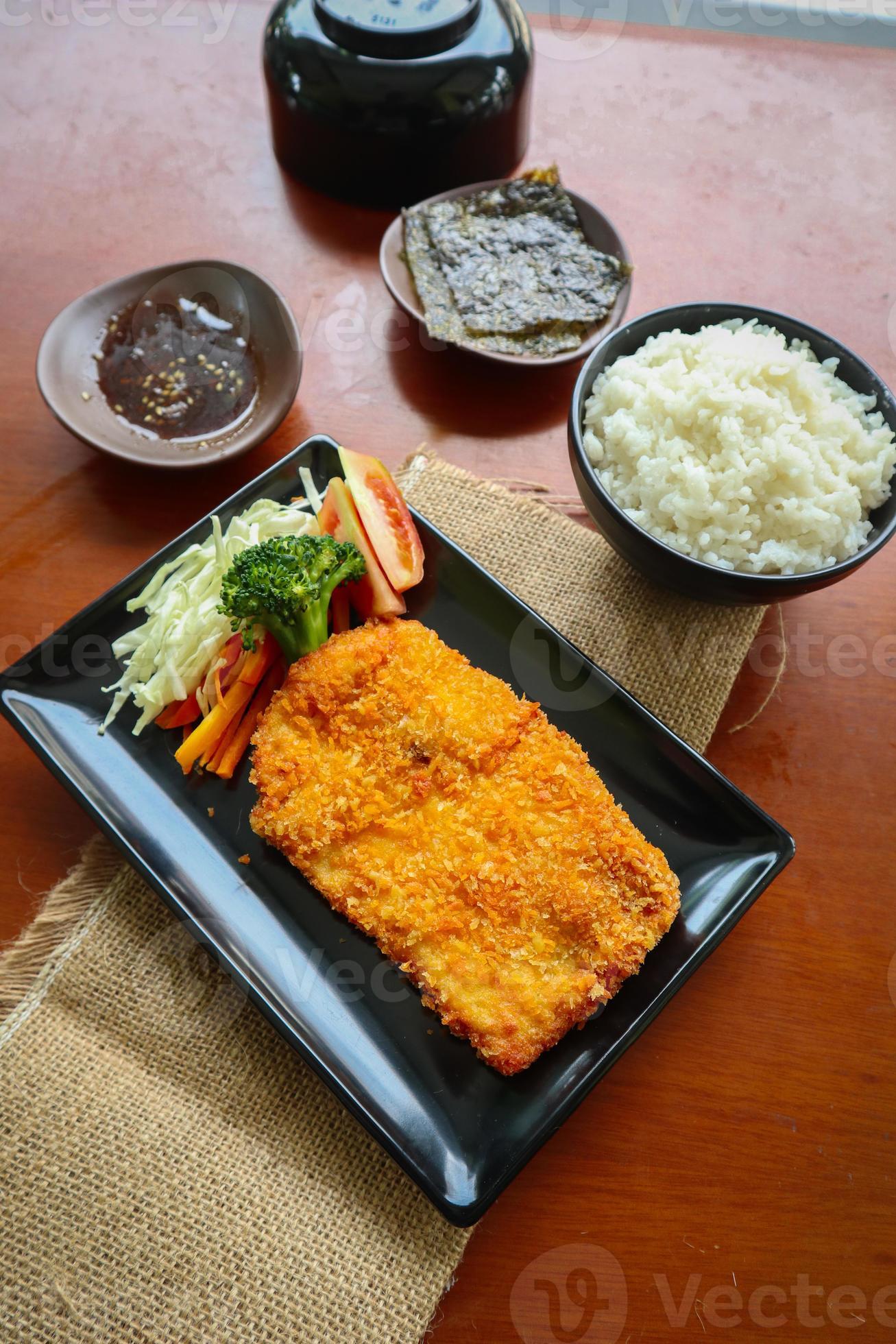 chicken katsu don is japanese food served with soy sauce on table 15958677 Stock Photo at Vecteezy