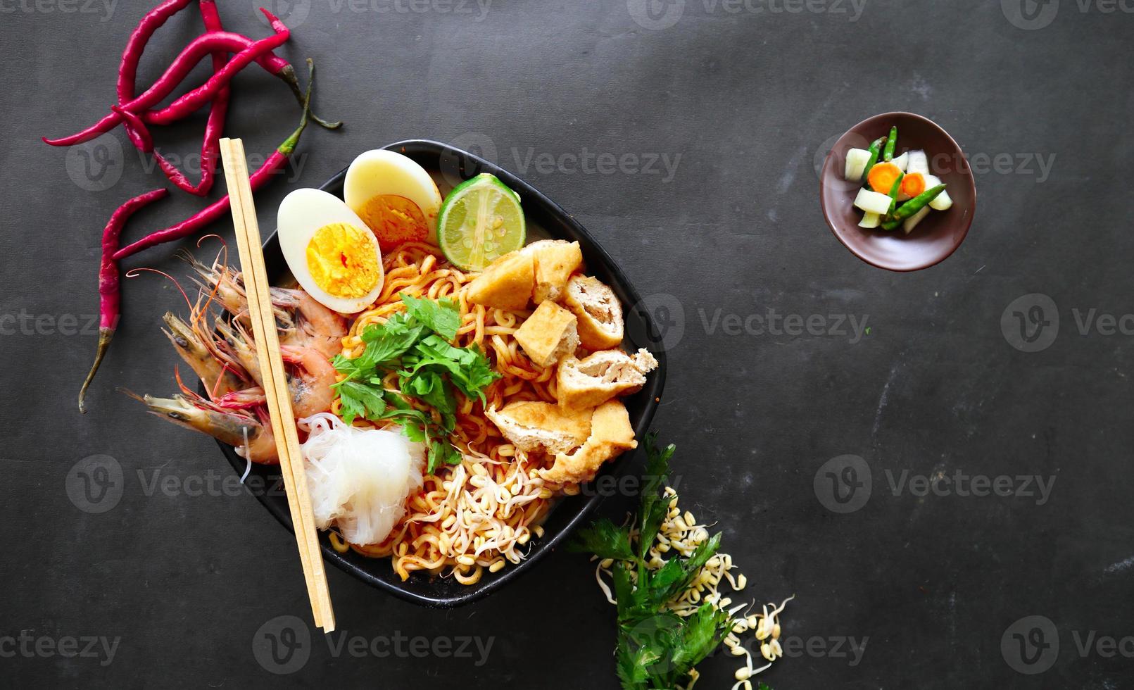 laksa, laksa curry made from vermicelli, noodles, bean sprouts, egg, tofu lime, and shrimp with a spicy soup sauce that is rich in spices. laksa served on bowl, isolated on white background. photo