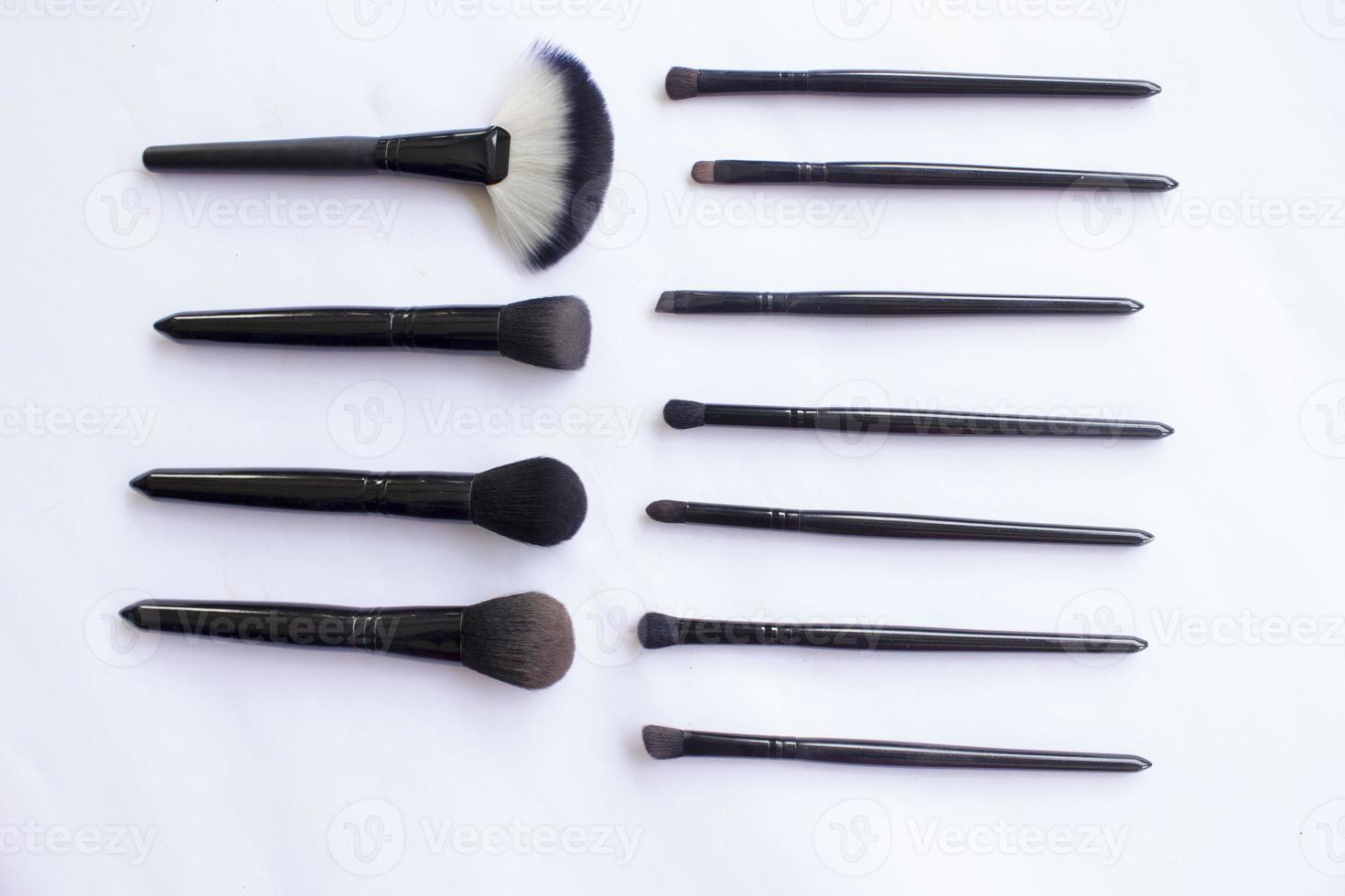 makeup brushes set isolated on white background. Top view, flat lay photo