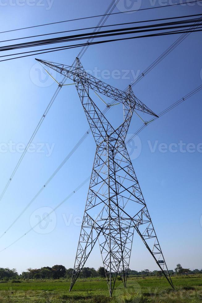 High voltage transmission towers. the pylon outline Very High Voltage Power Lines Indonesia  SUTET on blue sky photo