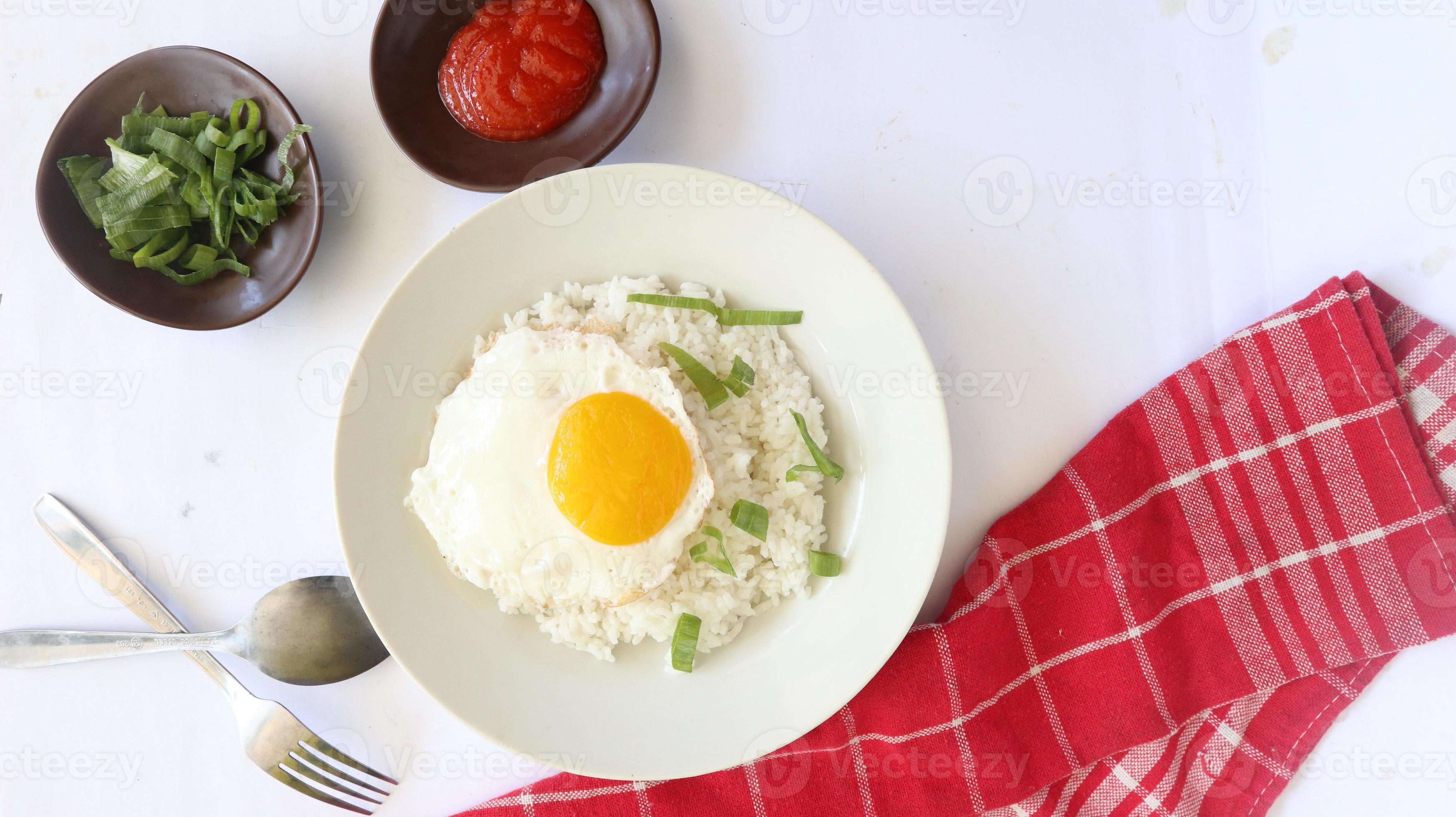 fried egg rice. breakfast fried egg sunny side rice on a plate, isolated on white background