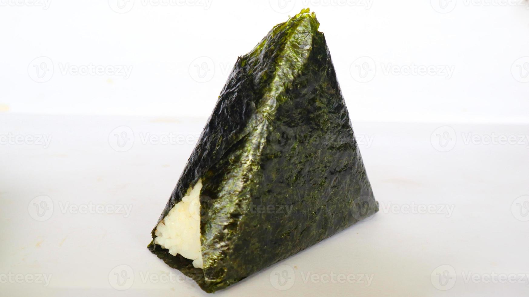Onigiri is Japanese food, Japanese rice ball, rice triangle with seaweed, nori isolated on with background photo