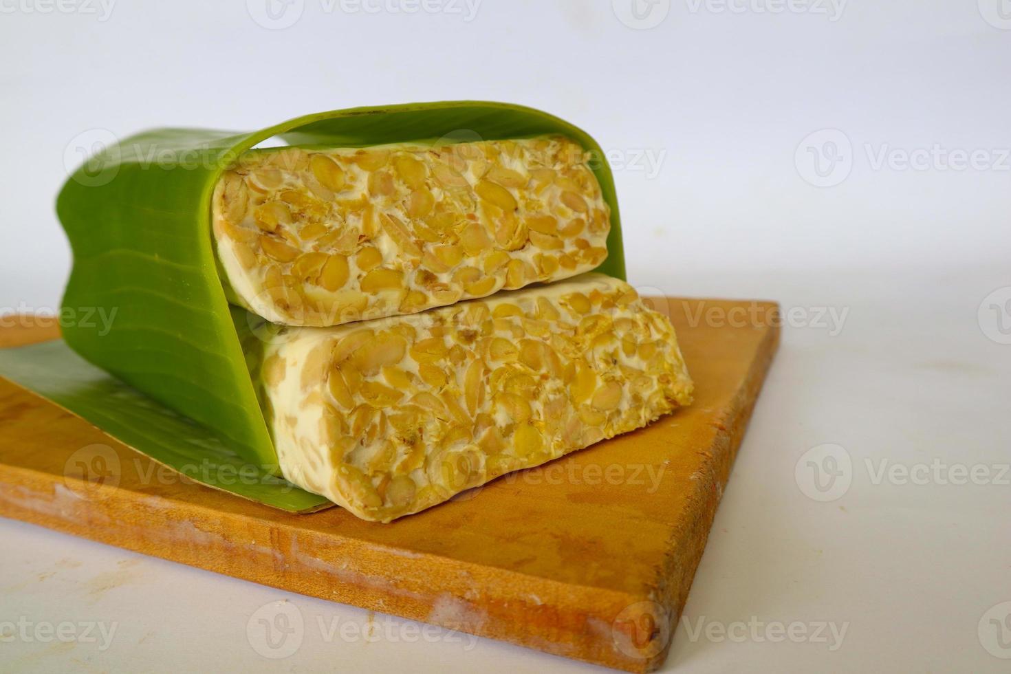 Raw tempeh or tempe. tempeh slices in white background. raw soybean seeds. Tempe is a traditional Indonesian food made from fermented soybeans. photo