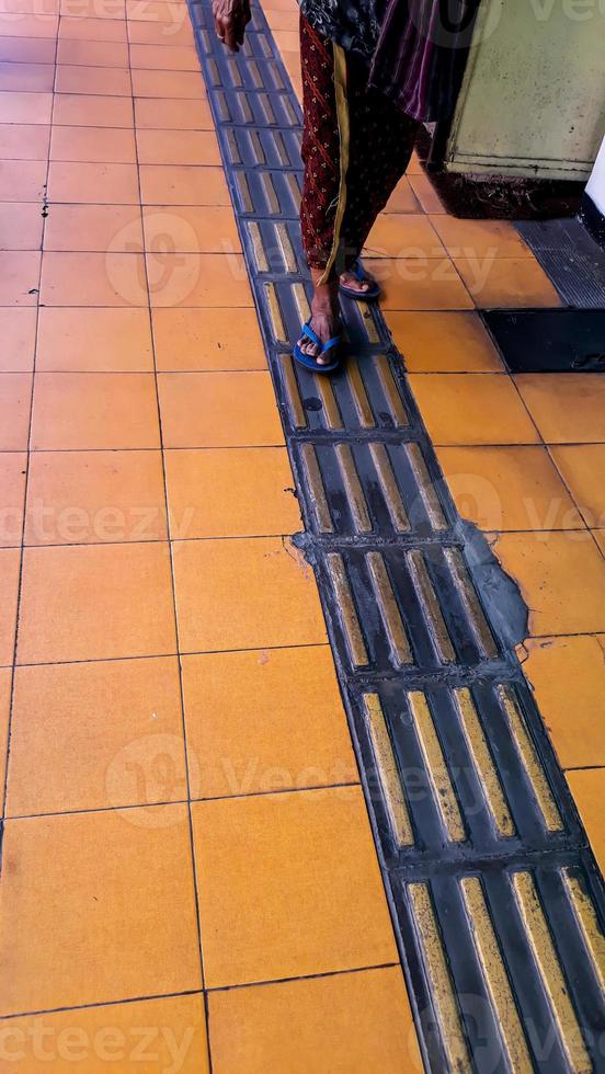 Guiding Block, Yellow Line Directions for the Blind. walking on yellow blocks of tactile paving for blind handicap. Braille blocks, tactile tiles for the visually impaired, photo