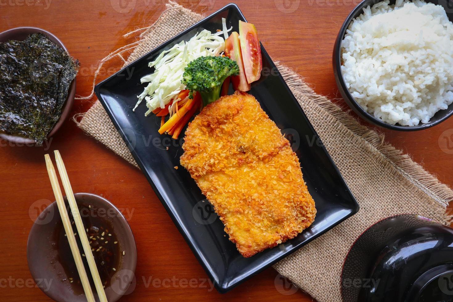 chicken katsu don is japanese food served with soy sauce on table 15959087 Stock Photo at Vecteezy