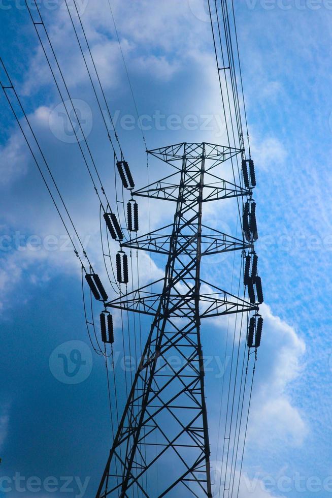 the pylon outline, Very High Voltage Power Lines Indonesia  SUTET on blue sky photo