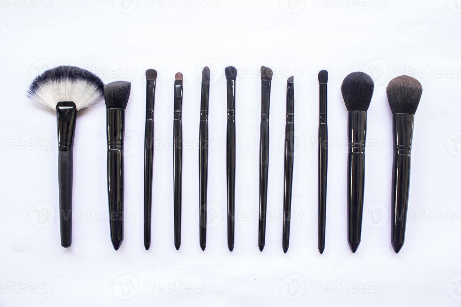 makeup brushes set isolated on white background. Top view, flat lay photo