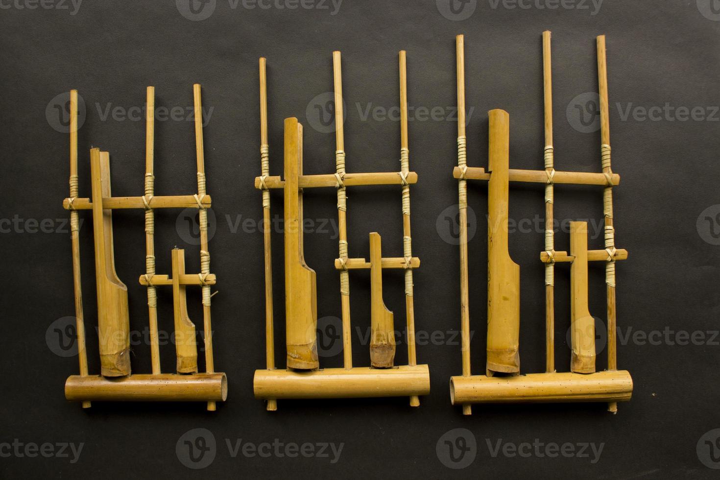 Angklung, the traditional sundanese musical instrument made from bamboo. Isolated on white background photo