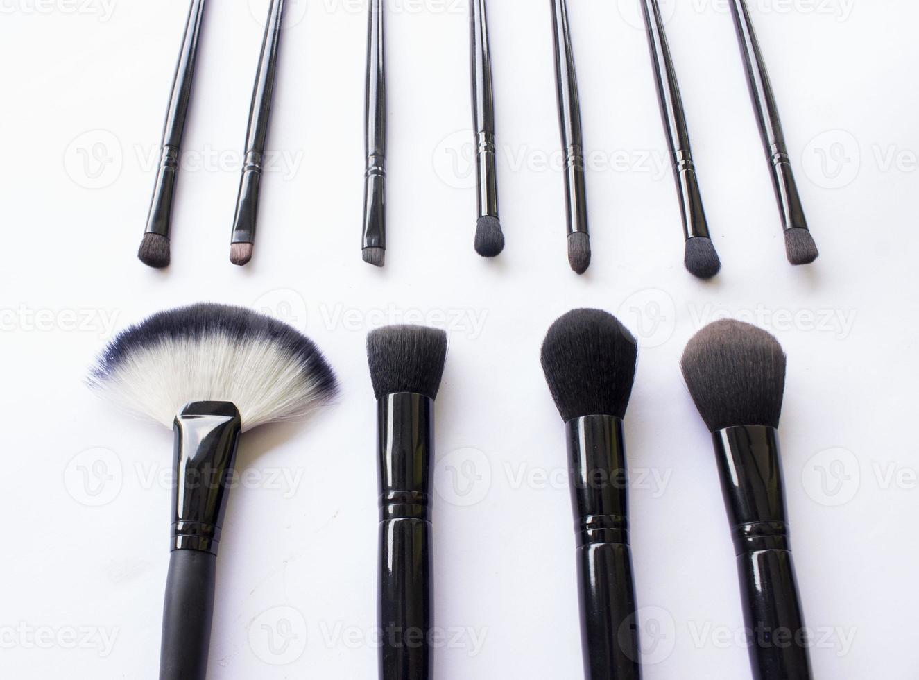 makeup brushes set isolated on white background. Top view, flat lay photo