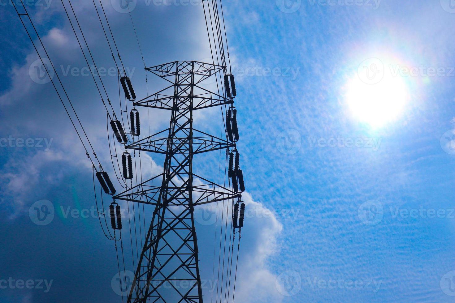the pylon outline, Very High Voltage Power Lines Indonesia  SUTET on blue sky photo