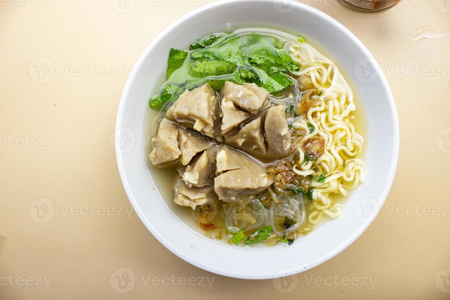 Bakso urat or meatball muscles is popular traditional food made from meat and cow muscles served with vegetables, noodle and flavour soup photo