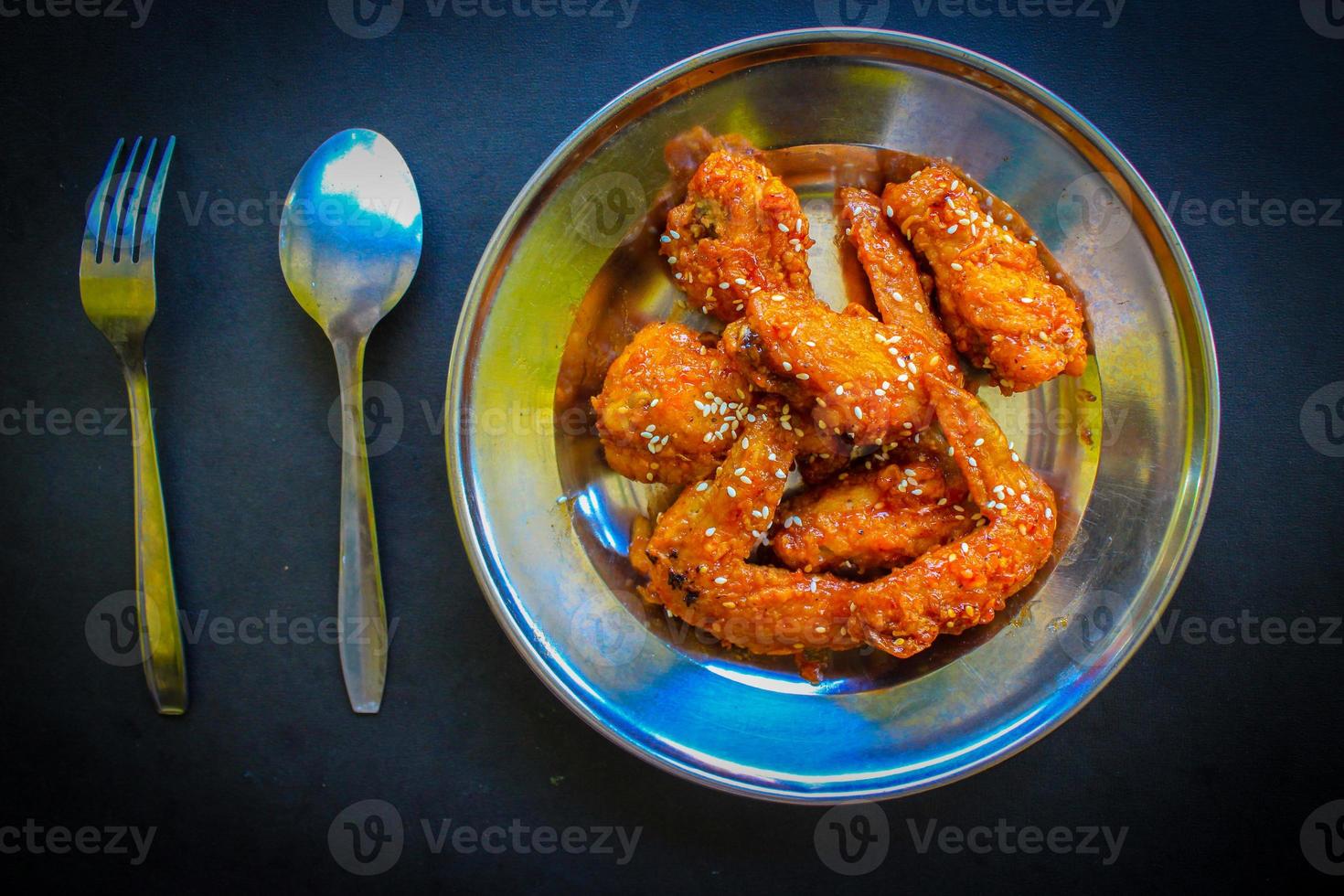 Delicious homemade crispy fried chicken with spicy taste and lemon on plate photo