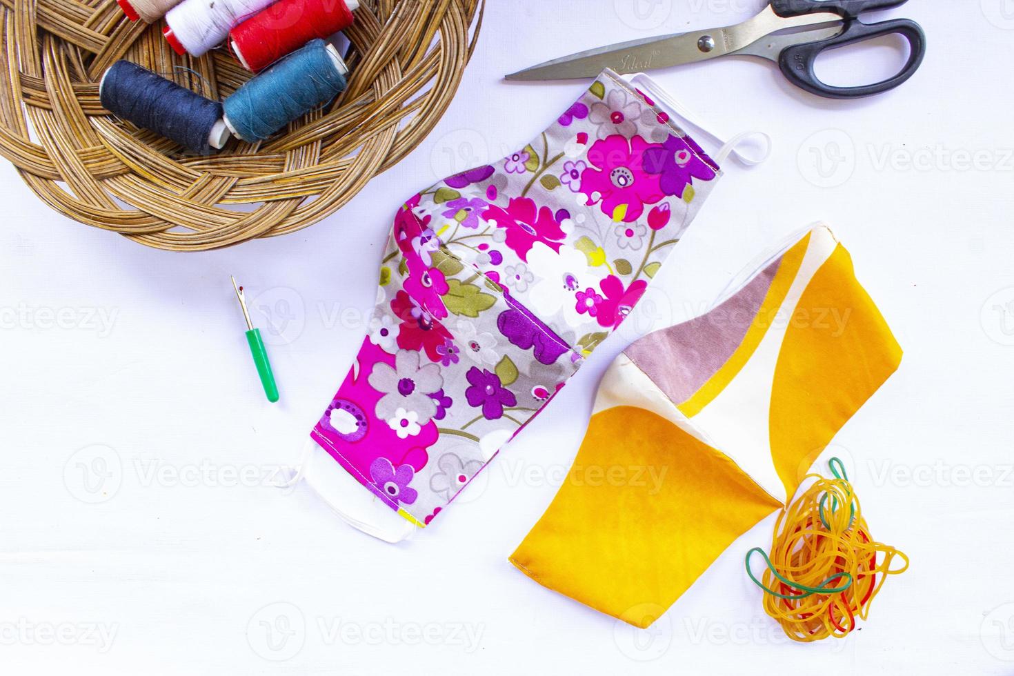 cloth mask or fabric face mask with cotton fabric flower pattern handmade crafts isolated on white background. This hygienic mask for cover mouth and protection with beautiful sewing fashion. photo