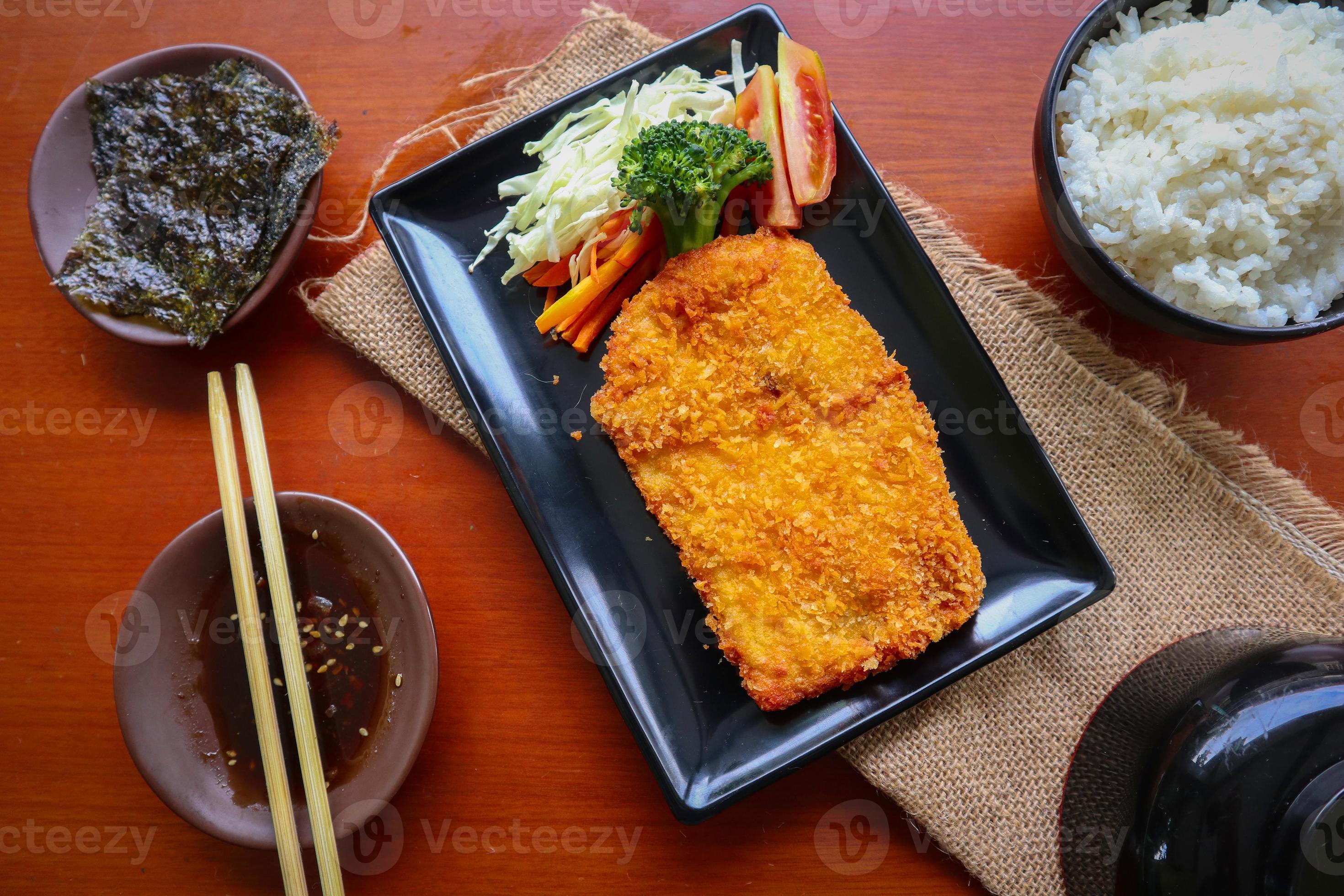 chicken katsu don is japanese food served with soy sauce on table 15960579 Stock Photo at Vecteezy