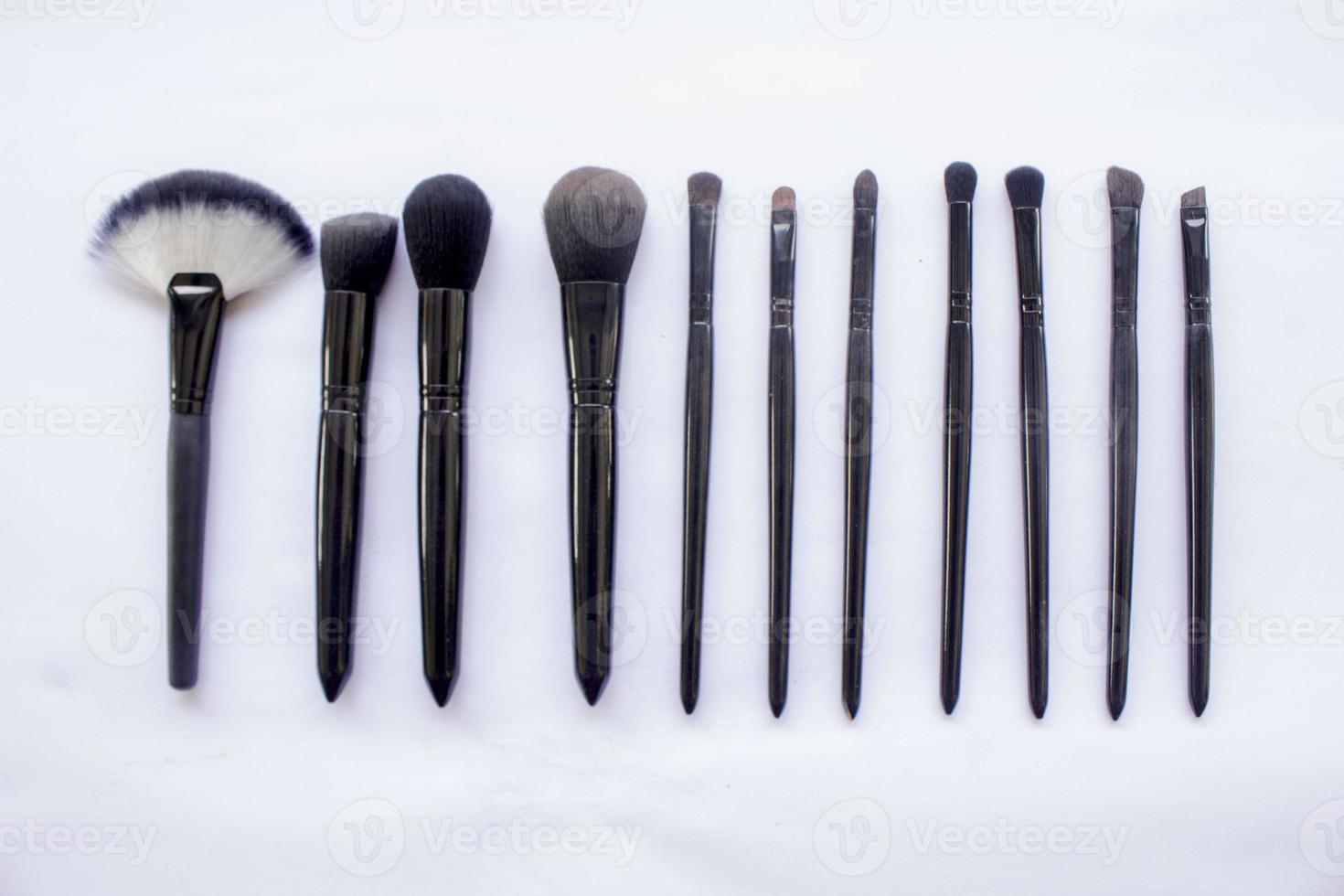 makeup brushes set isolated on white background. Top view, flat lay photo