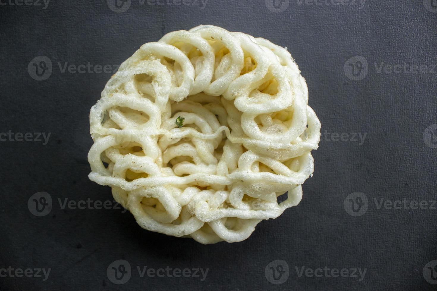 kerupuk or krupuk or crackers isolated on black background. kerupuk is snacks made from tapioca flour dough mixed with flavorings such as shrimp or fish. traditional snack from indonesia photo