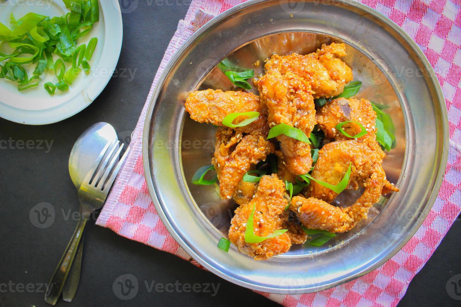 Delicious homemade crispy fried chicken with spicy taste and lemon on plate photo