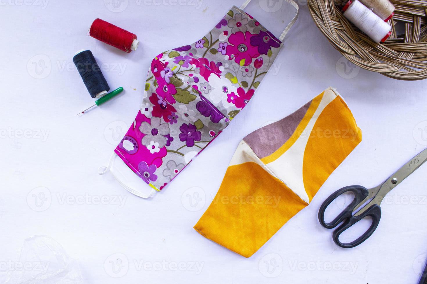 cloth mask or fabric face mask with cotton fabric flower pattern handmade crafts isolated on white background. This hygienic mask for cover mouth and protection with beautiful sewing fashion. photo