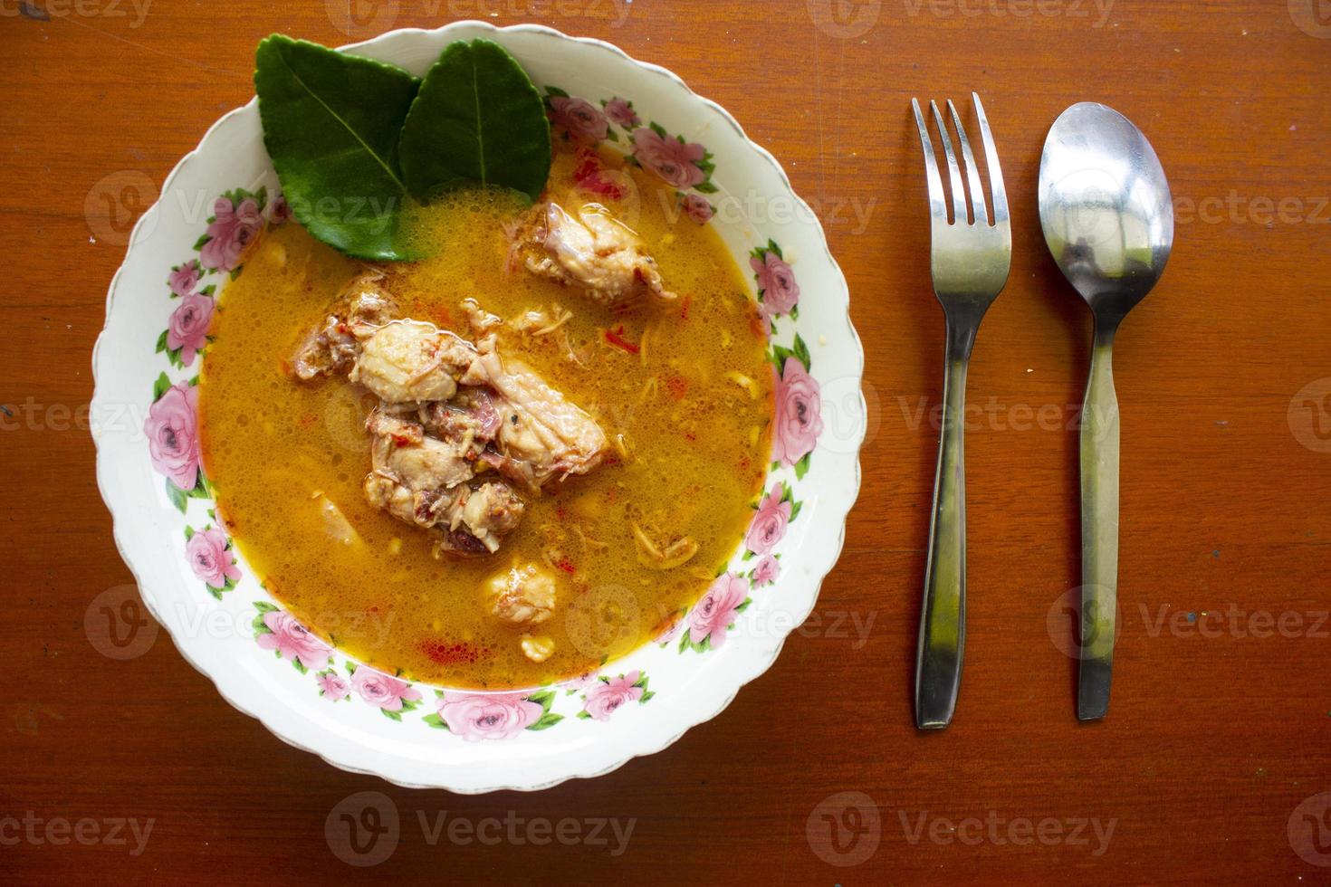 chicken curry or kari ayam served on bowl, isolated on white background photo