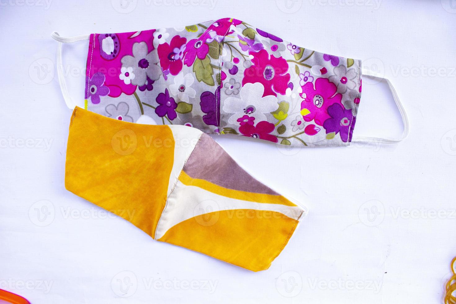 cloth mask or fabric face mask with cotton fabric flower pattern handmade crafts isolated on white background. This hygienic mask for cover mouth and protection with beautiful sewing fashion. photo