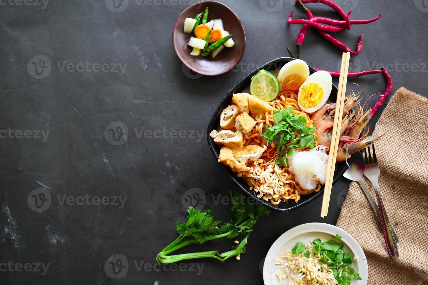 laksa, laksa curry made from vermicelli, noodles, bean sprouts, egg, tofu lime, and shrimp with a spicy soup sauce that is rich in spices. laksa served on bowl, isolated on white background. photo