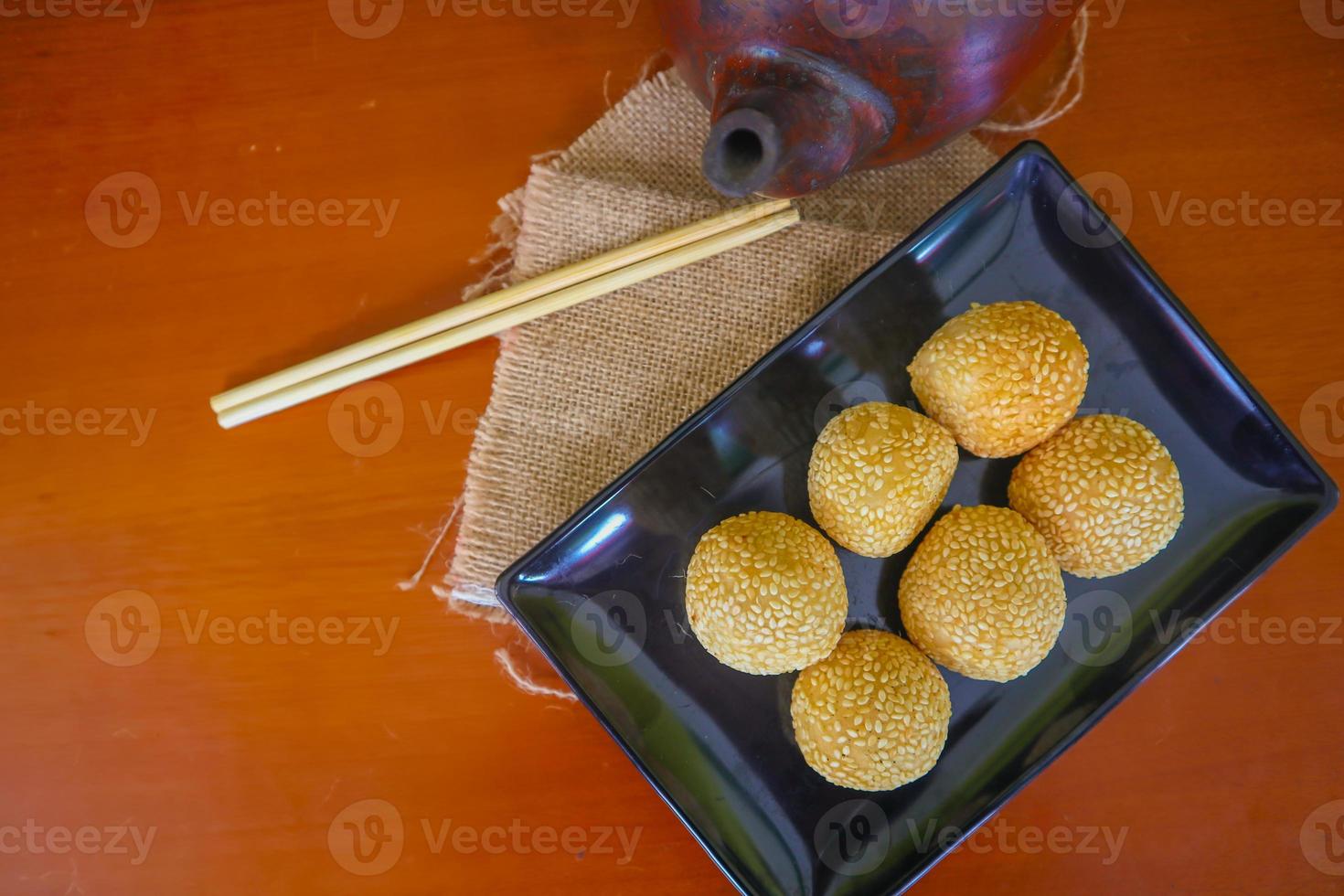onde-onde or sesame ball or Jian Dui is fried Chinese pastry made from glutinous rice flour and coated with sesame seeds filled with bean paste. isolated on white background photo