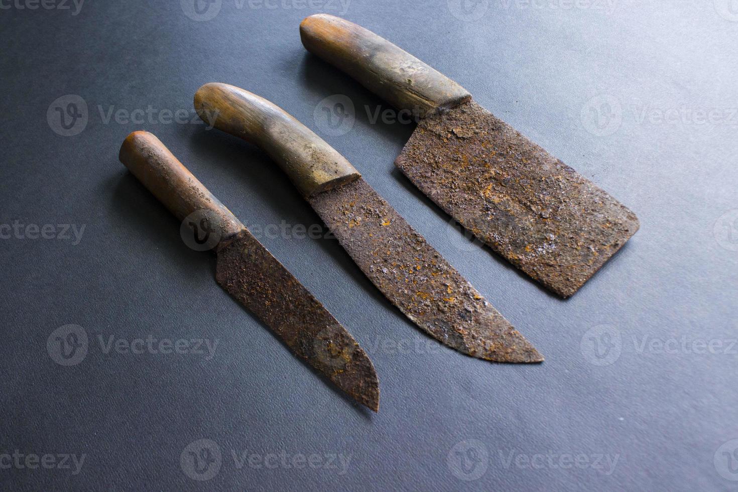 Rusty meat knife isolated on stone backgroundRusty meat knife isolated on stone background photo