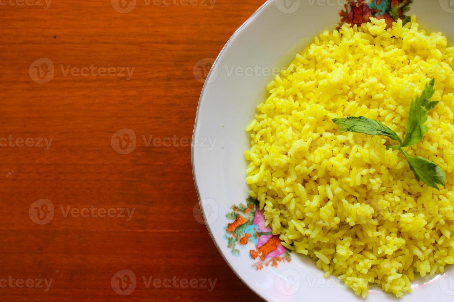yellow rice or turmeric rice or nasi kuning is food made from rice cooked with turmeric, coconut milk and spices. so the taste is more savory photo