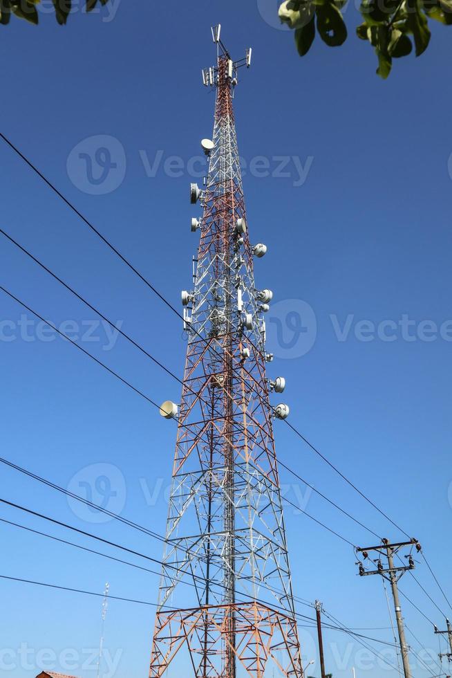 communication tower. Telco Trellis for 3G 4G 5G Apocalypse Internet Communication, mobile, FM Radio and Television Broadcasting On Air with Blue Sky in Background photo