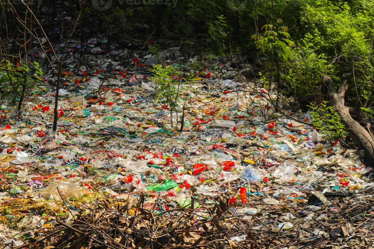 Spilled plastic garbage on the land of the big city. Empty used dirty plastic bottles. Plastic pollution. Environmental pollution. Ecological problem. photo