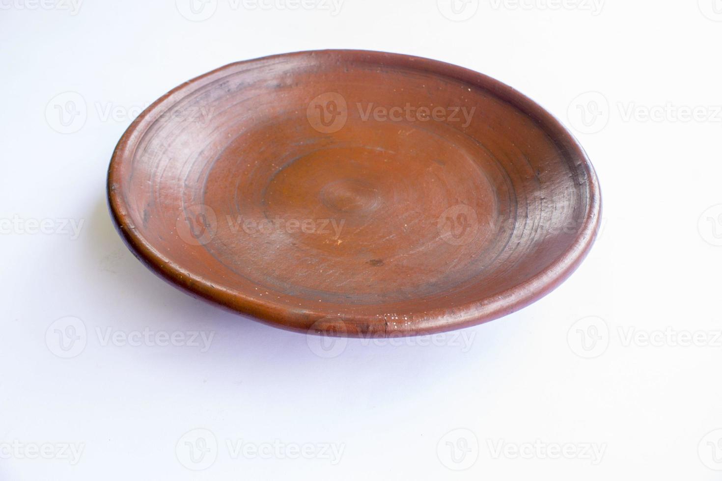 earthenware plate isolated on white background. earthenware crafts photo