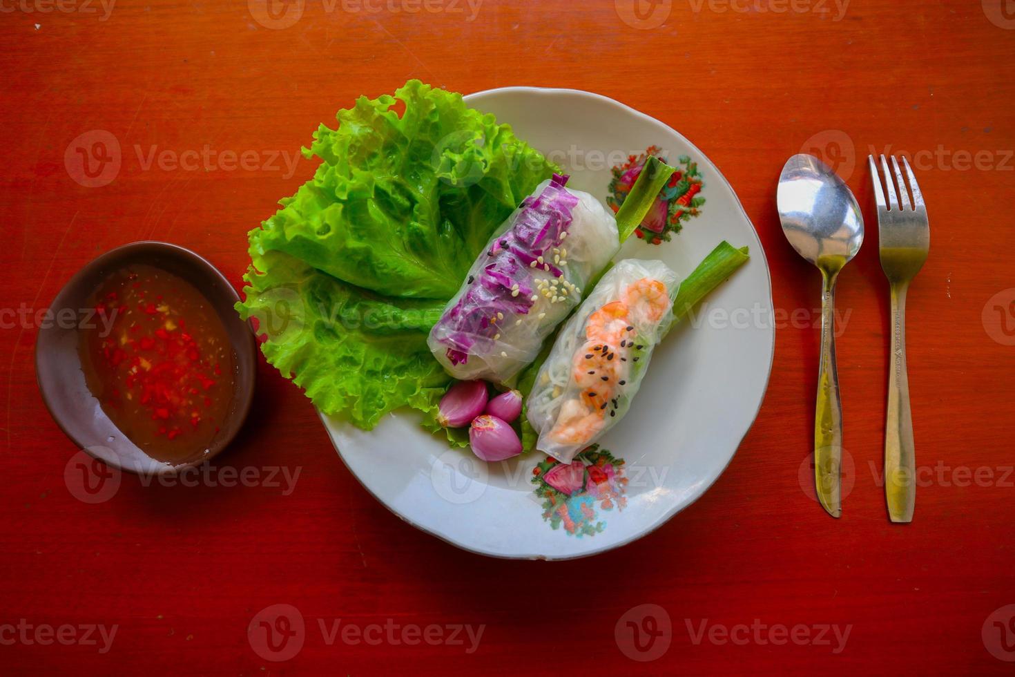 Goi cuon is a traditional spring roll from Vietnam , Vietnamese food, made from meat, shrimp, vegetables, vermicelli, wrapped in rice paper or banh trang. served with sauce photo
