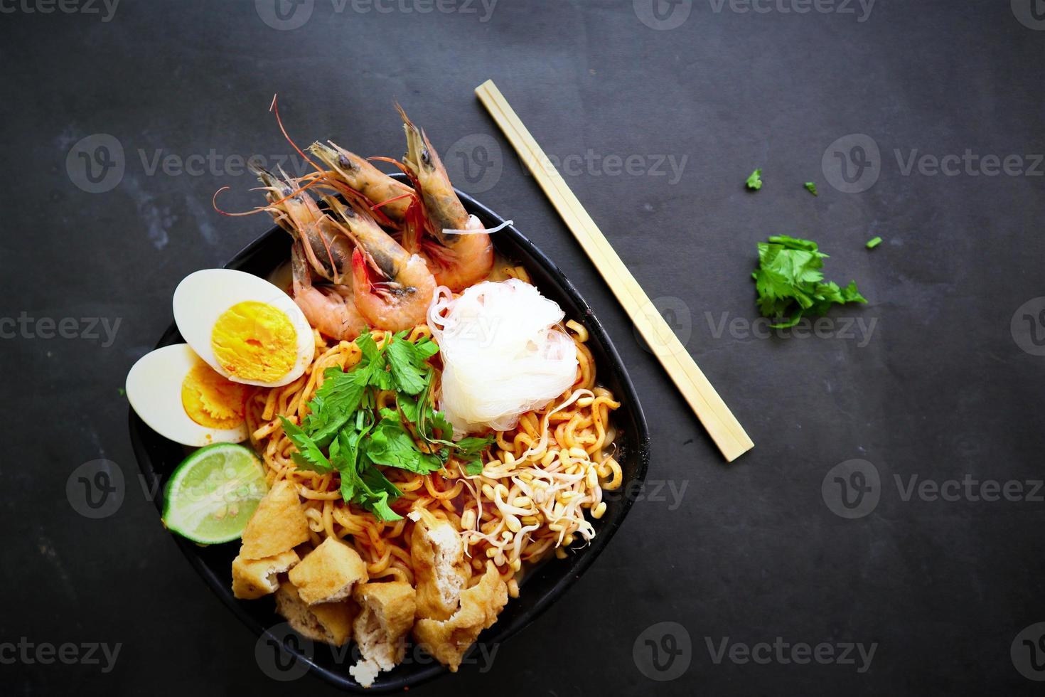 laksa, laksa curry made from vermicelli, noodles, bean sprouts, egg, tofu lime, and shrimp with a spicy soup sauce that is rich in spices. laksa served on bowl, isolated on white background. photo