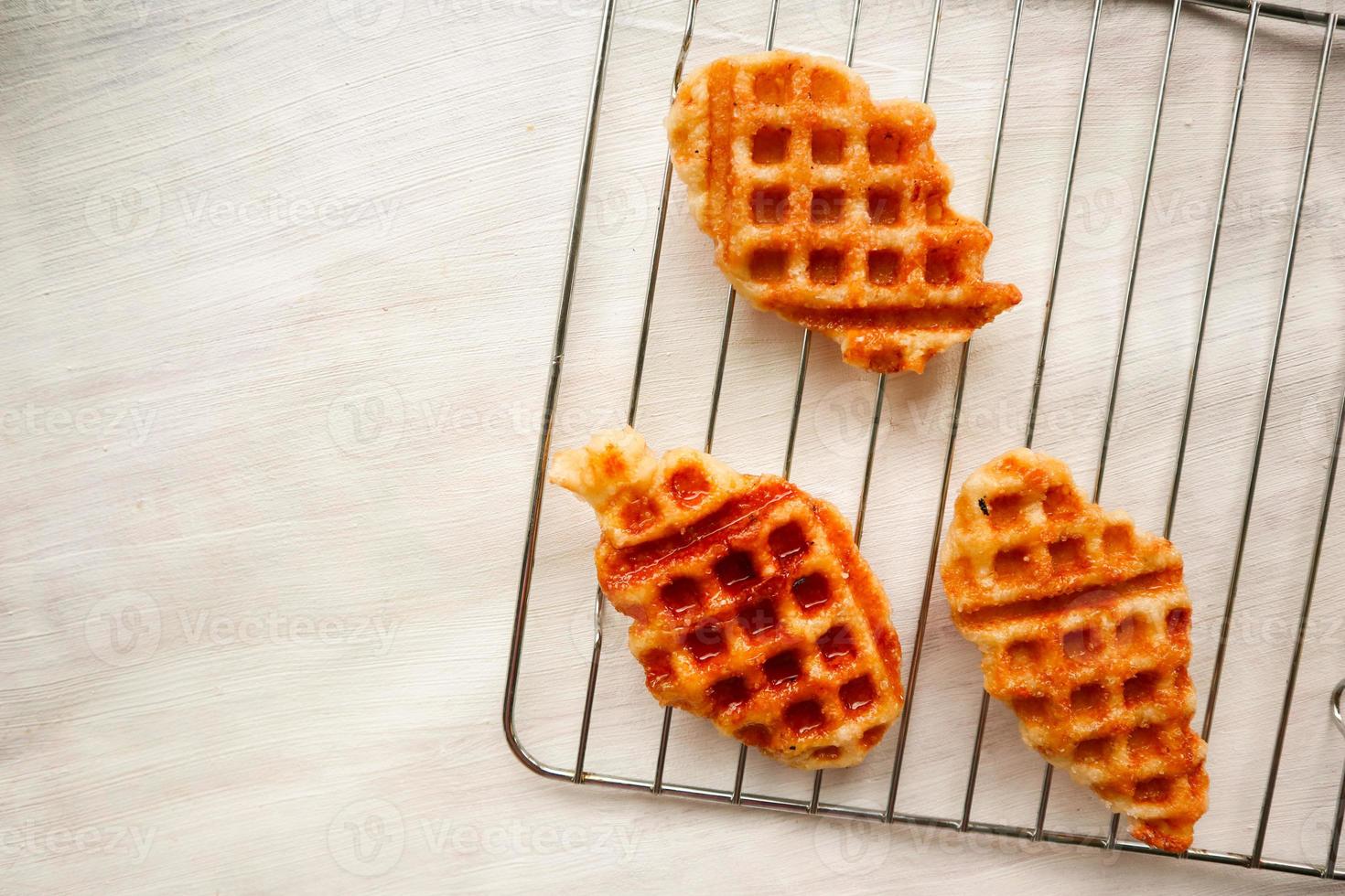 Croissant Waffle or Croffle with chocolate sauce served in box and white background photo