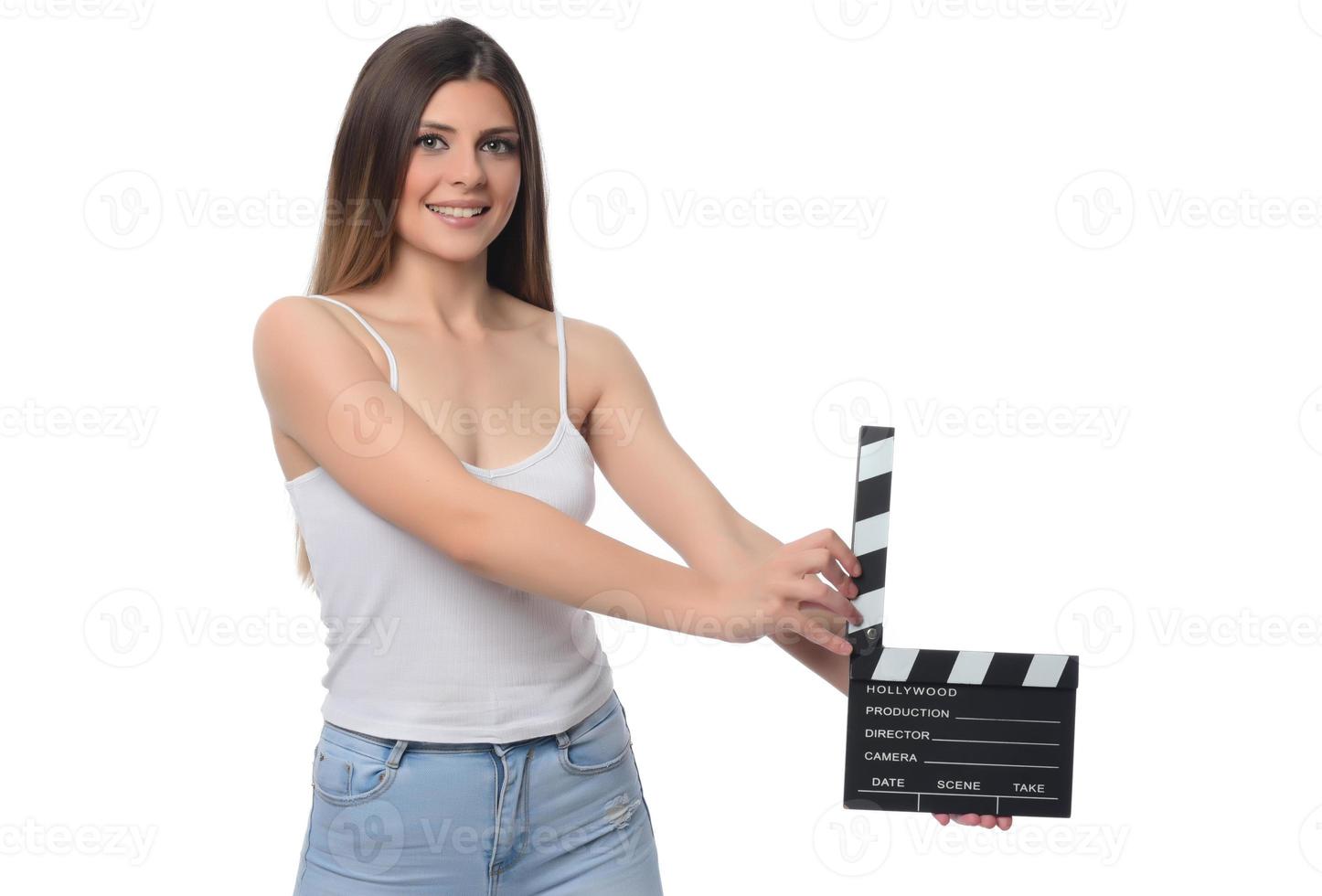 beautiful young woman with cinema clapper posing in studio. Movie concept. isolated photo
