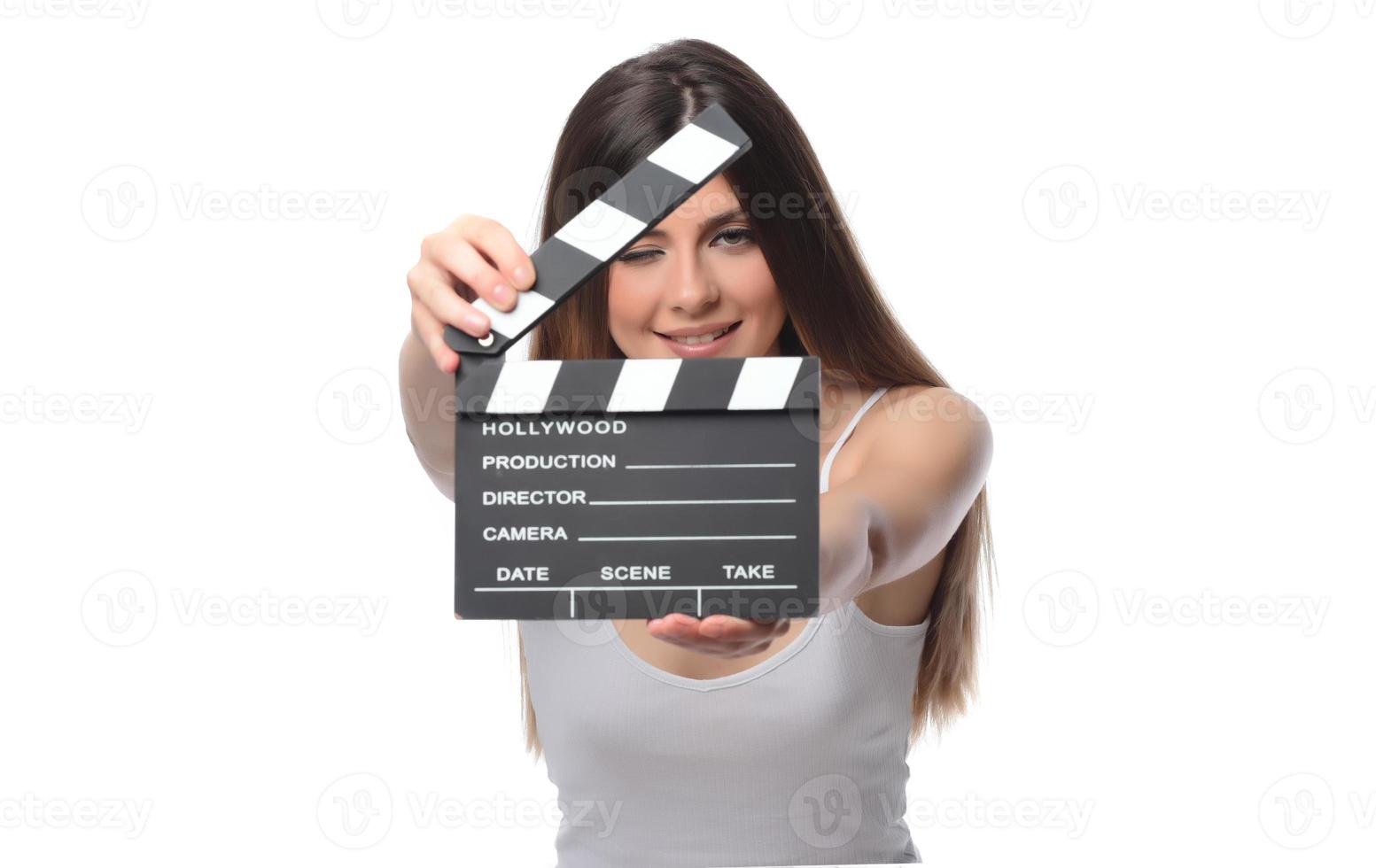 beautiful young woman with cinema clapper posing in studio. Movie concept. isolated photo