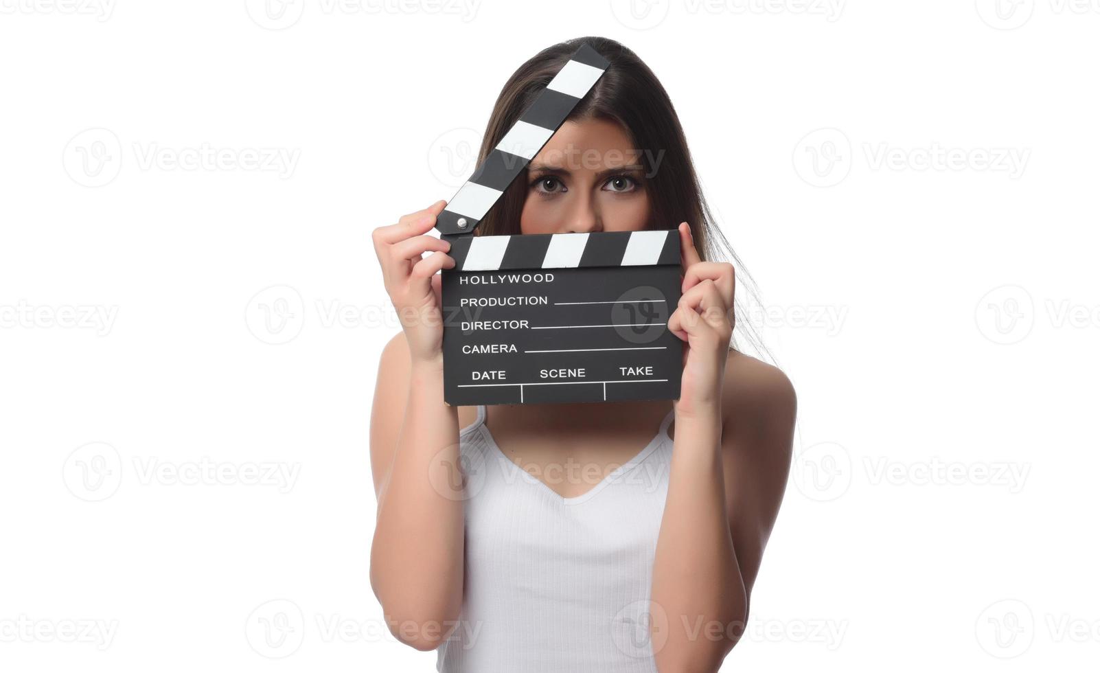 beautiful young woman with cinema clapper posing in studio. Movie concept. isolated photo