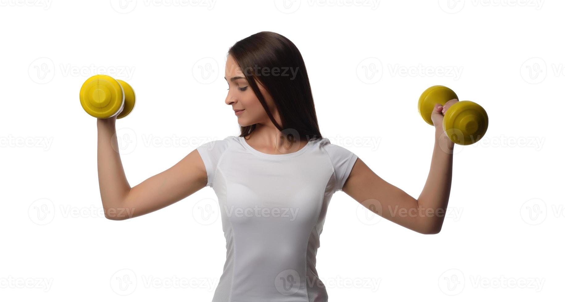 Determined woman losing weight and exercising with dumbbells photo