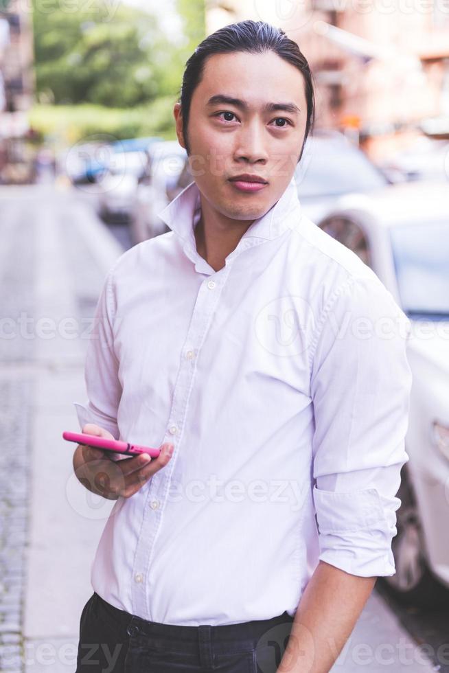 ASIAN business male model talking on his cell phone photo