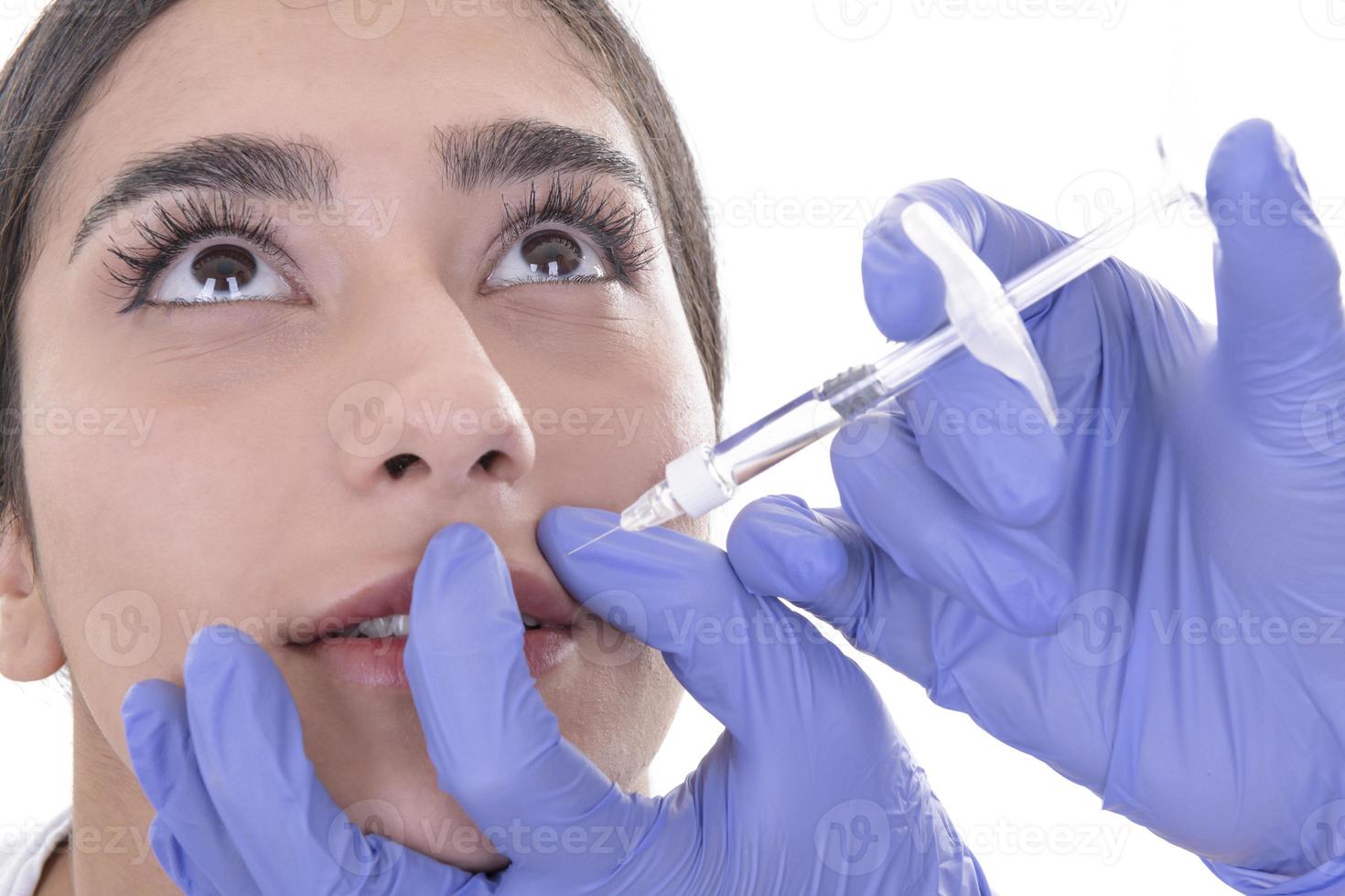 young woman gets injection of botox. anti-aging injection photo