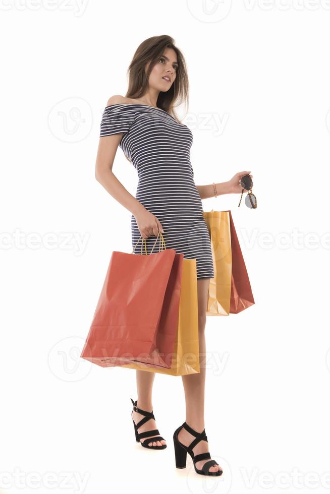 Young Modern Beautiful woman holding a lot of shopping bags photo