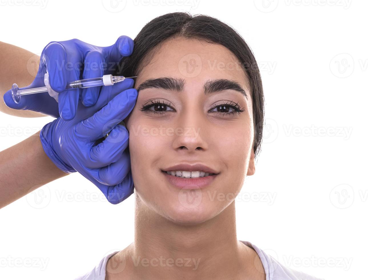young woman gets injection of botox. anti-aging injection photo
