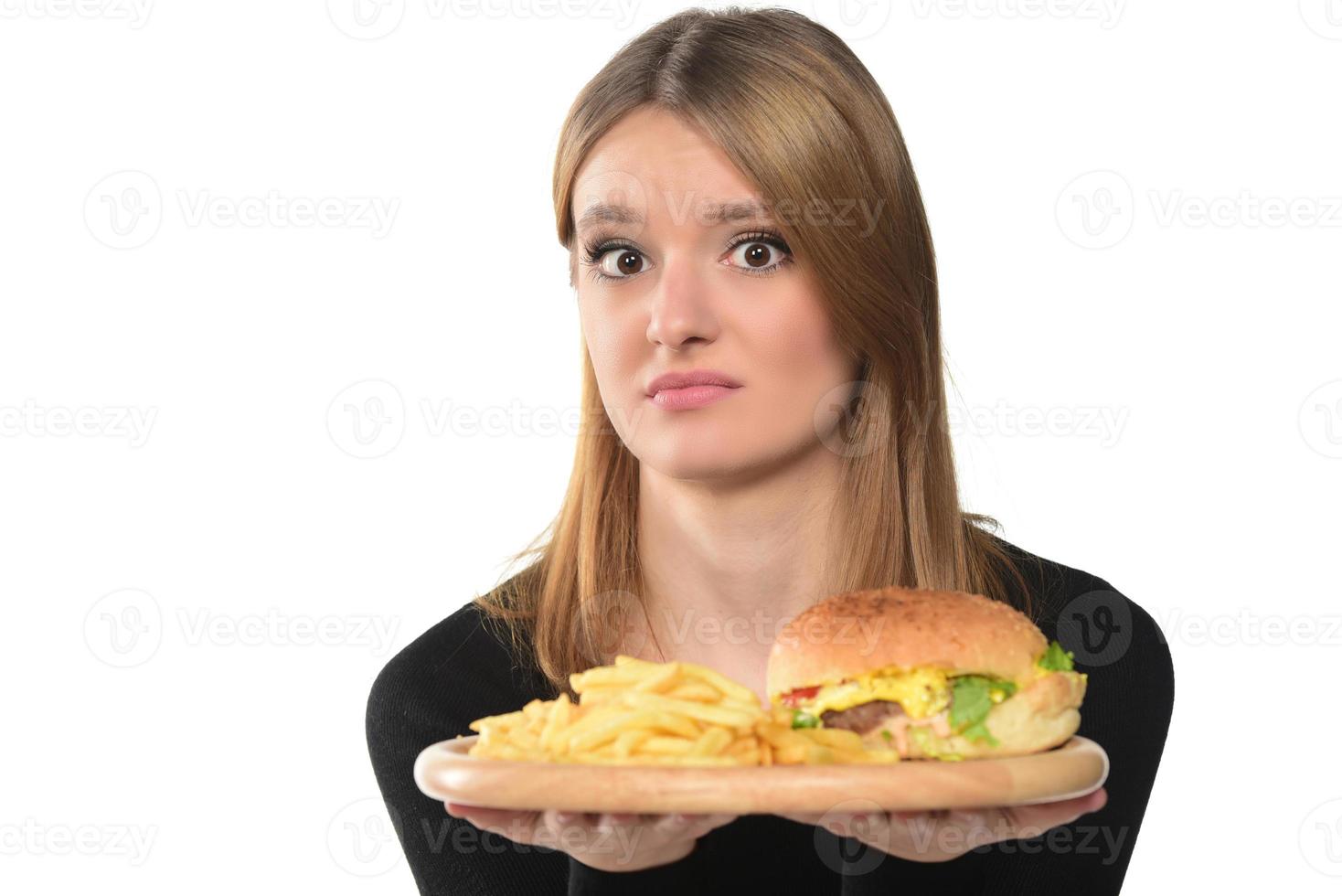 portrait of a beautiful funny young girl eating hamburger. photo