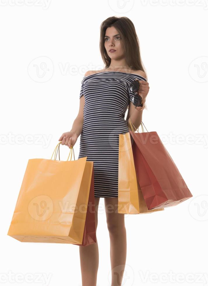 Young Modern Beautiful woman holding a lot of shopping bags photo