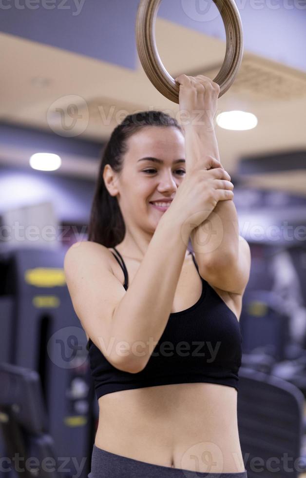 Woman doing a workout with dumbbells at the fitness gym. photo