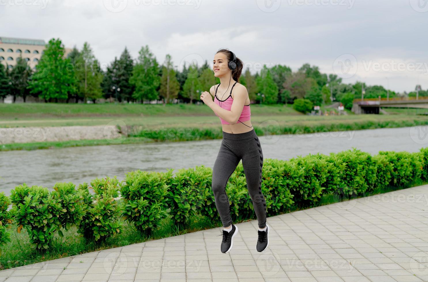 Sports Woman jogging down at urban outdoor trail. photo