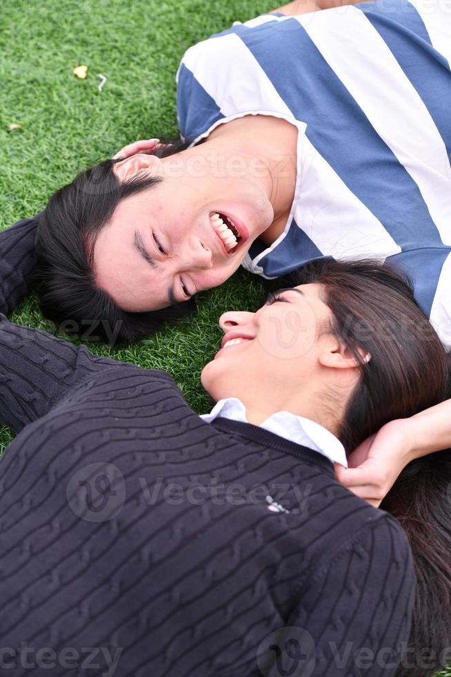 Mixed Couple relaxing In the park photo