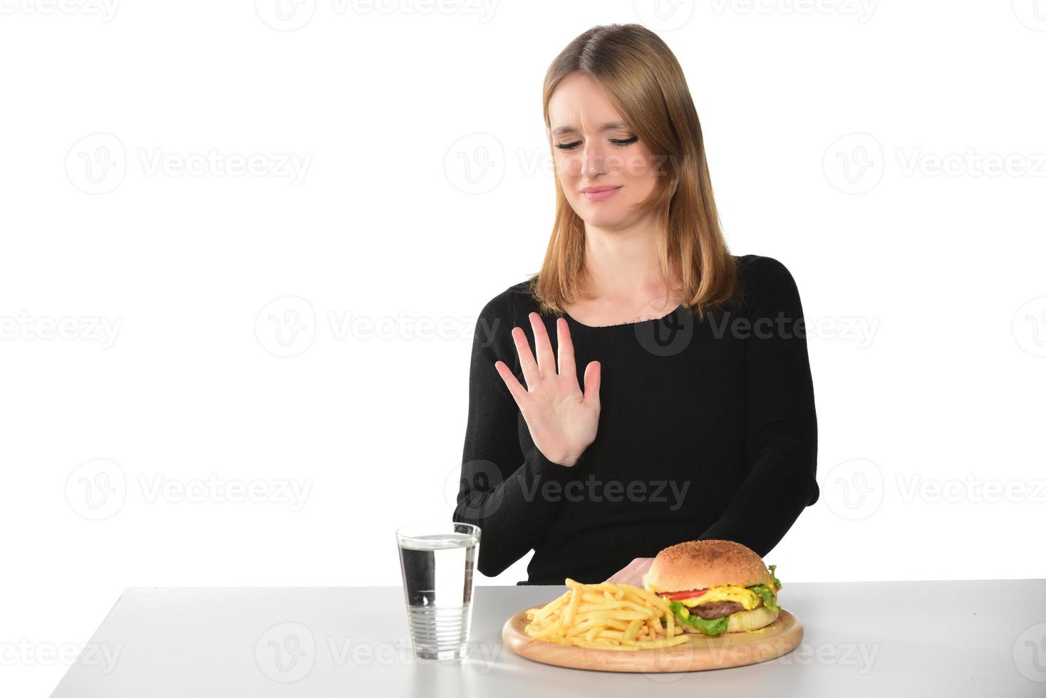 portrait of a beautiful funny young girl eating hamburger photo