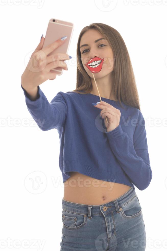 Beauty funny teenage girl making selfie with her cellphone photo